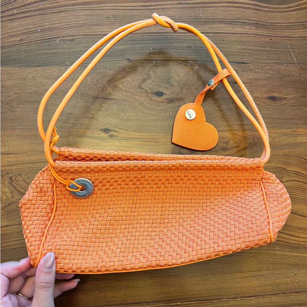 The Sak Orange Crochet Mini Bag with Mirror & Charm